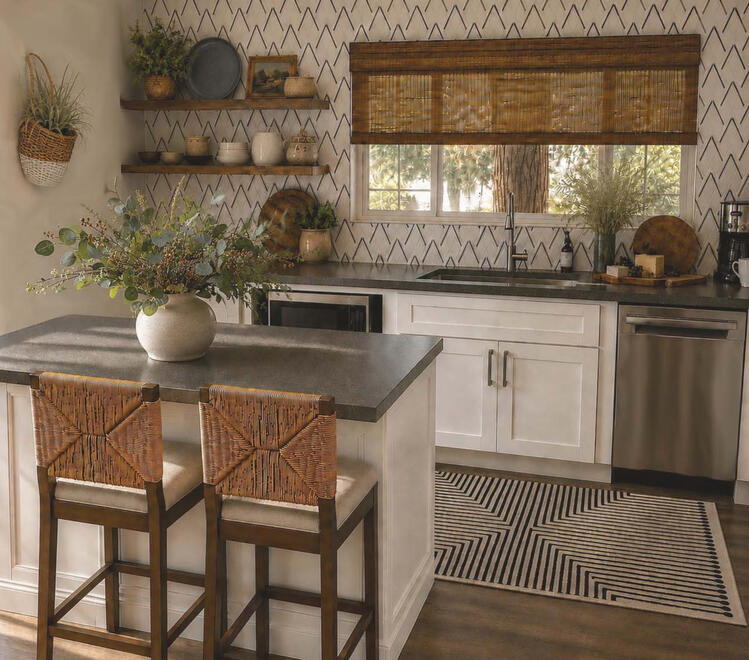 PETITE SUITE KITCHEN— This build-out was thoughtfully designed to maximize both style and functionality, creating a cohesive and welcoming space through the balance of modern stone surfaces and warm, natural finishes.