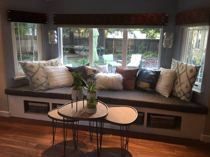 URBAN ORGANIC LOUNGE— A contemporary seating area that blends sharp, modern furniture lines with organic textures, cozy textiles, and fluid outdoor views.