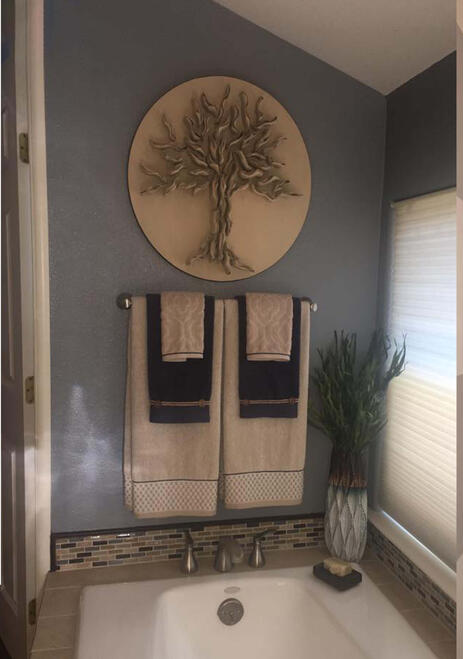 TAILORED TRANSITIONAL— This compact powder room showcases the power of layering rich textures to transform a small space into an inviting, high-end sanctuary.